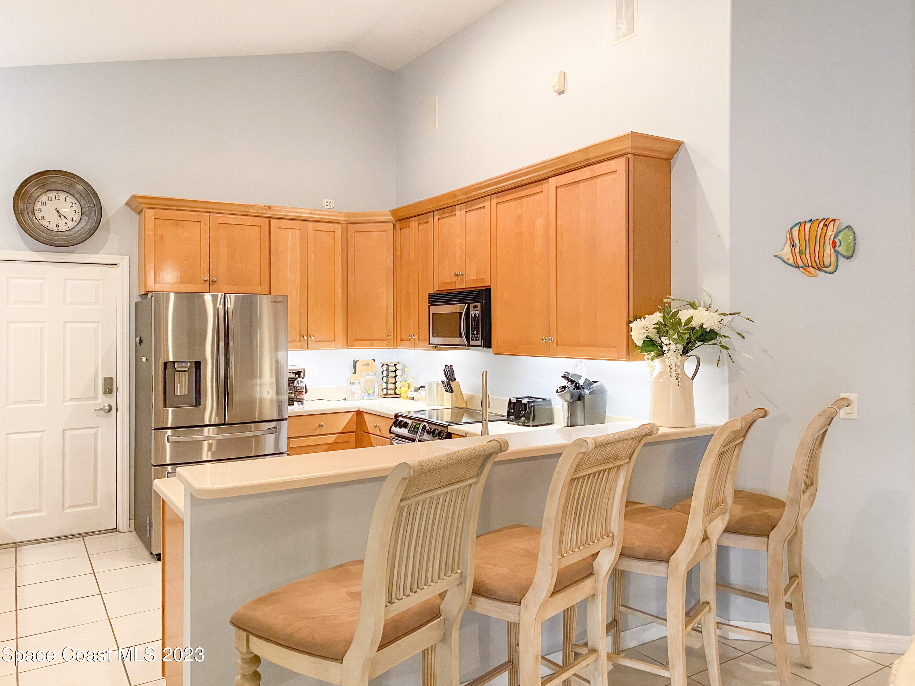 5080 Seiler Street Melbourne Beach, FL 32951 - Photo 5 of 34 a dining room with furniture a window and stainless steel appliances