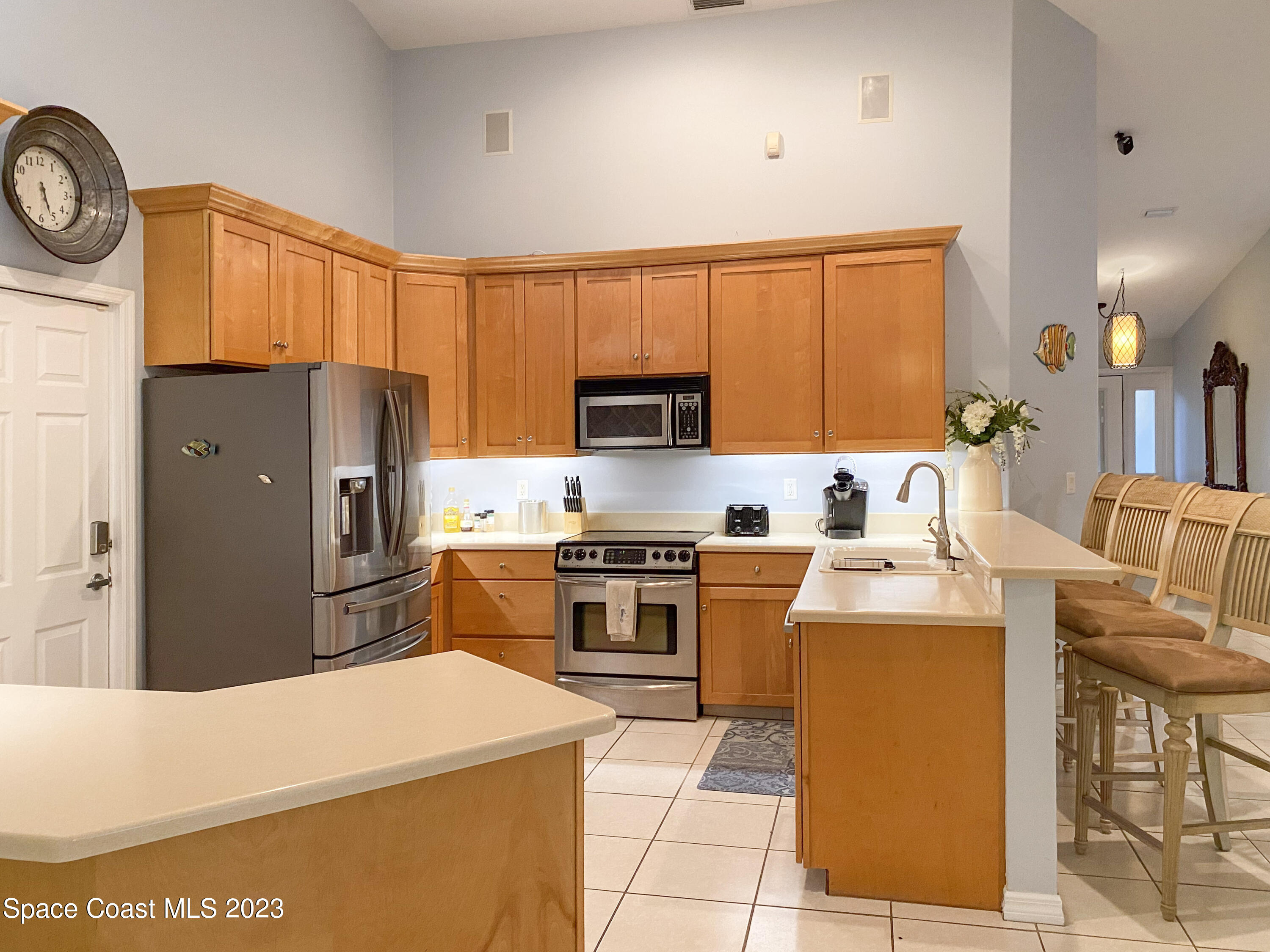 5080 Seiler Street Melbourne Beach, FL 32951 - Photo 6 of 34 a kitchen with stainless steel appliances granite countertop a refrigerator stove microwave and sink