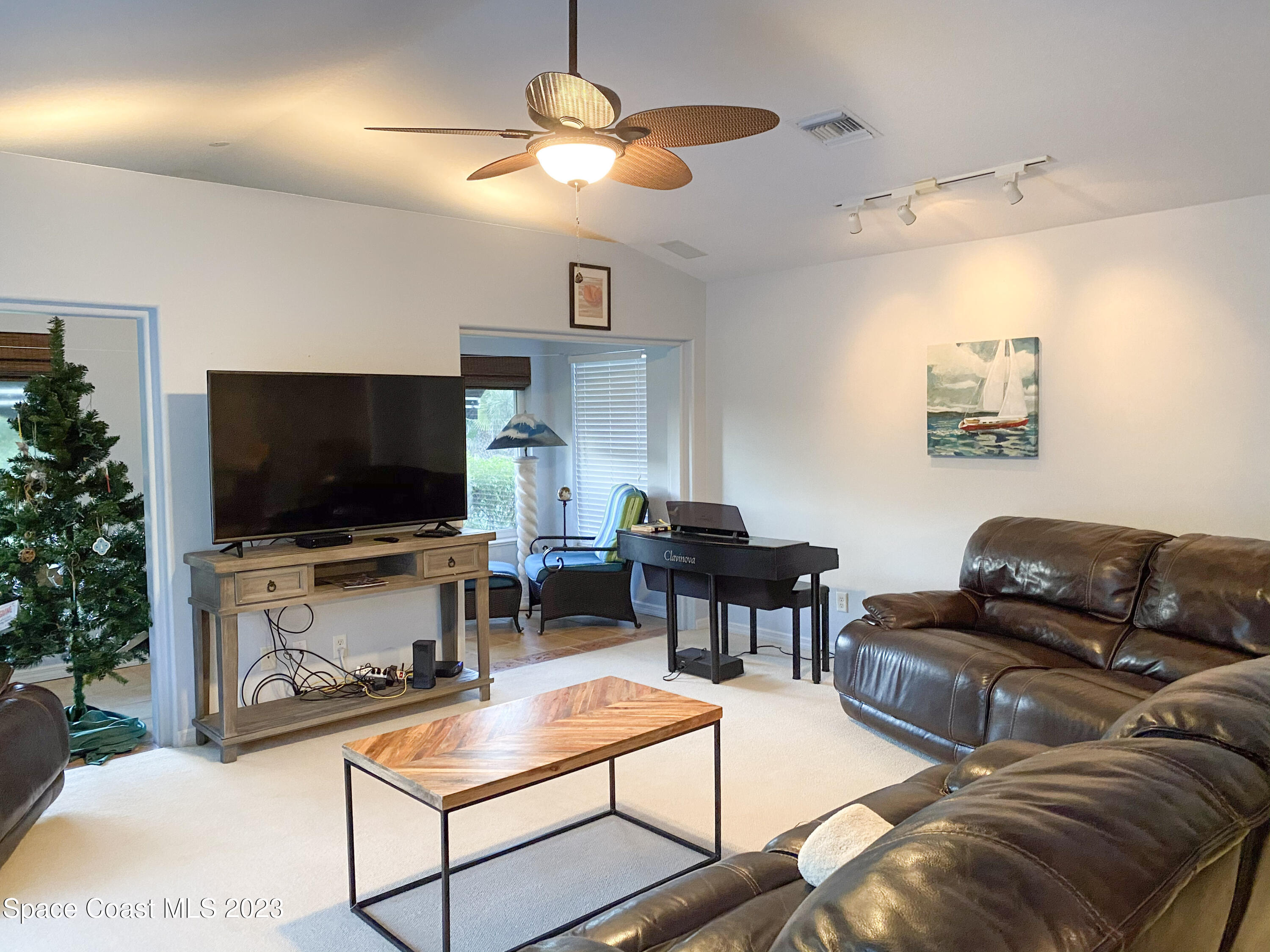 5080 Seiler Street Melbourne Beach, FL 32951 - Photo 10 of 34 a living room with furniture and a flat screen tv