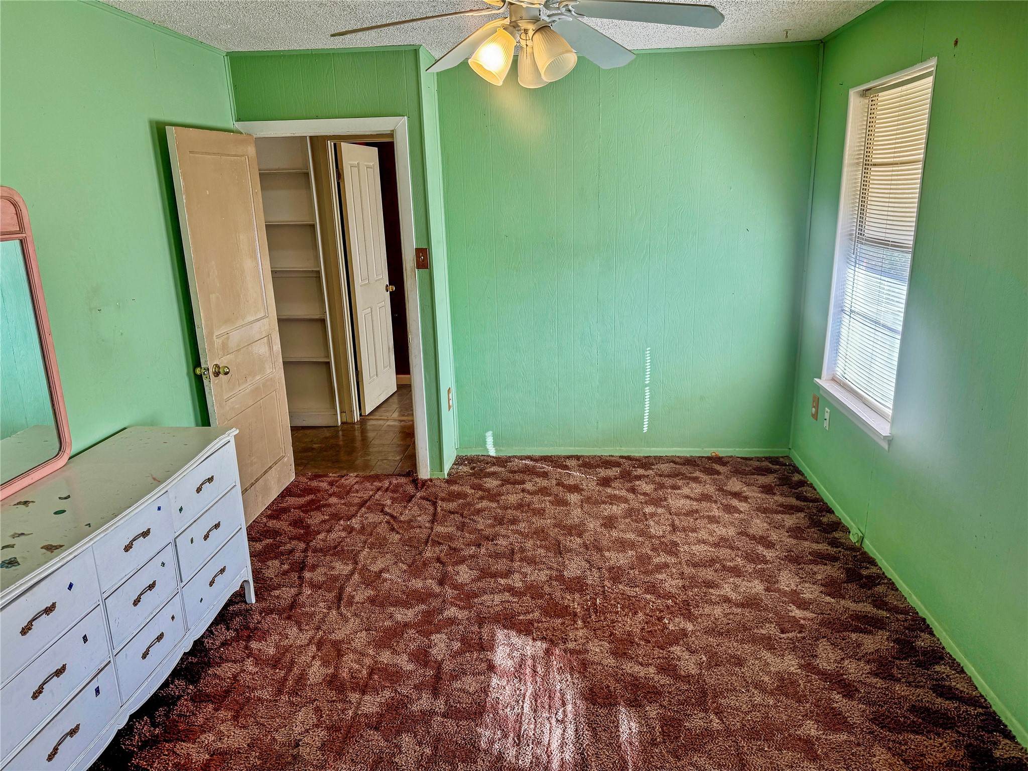 4672 Rakowitz Road Adkins, TX 78101 - Photo 20 of 38 a bedroom with a bed and a mirror