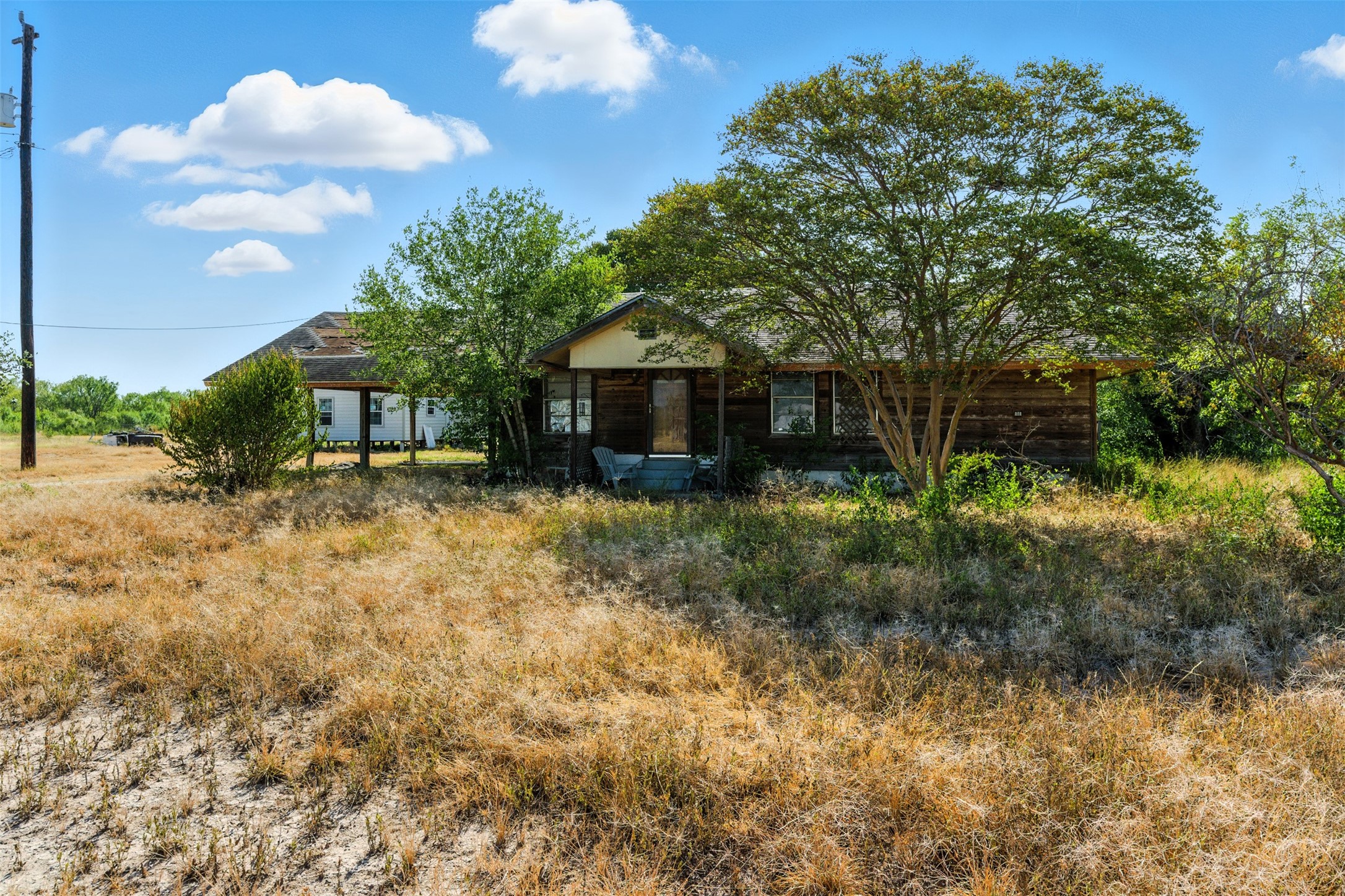 4672 Rakowitz Road Adkins, TX 78101 - Photo 2 of 38 From this vantage point, the home blends into its wide-open surroundings, highlighting its country appeal.