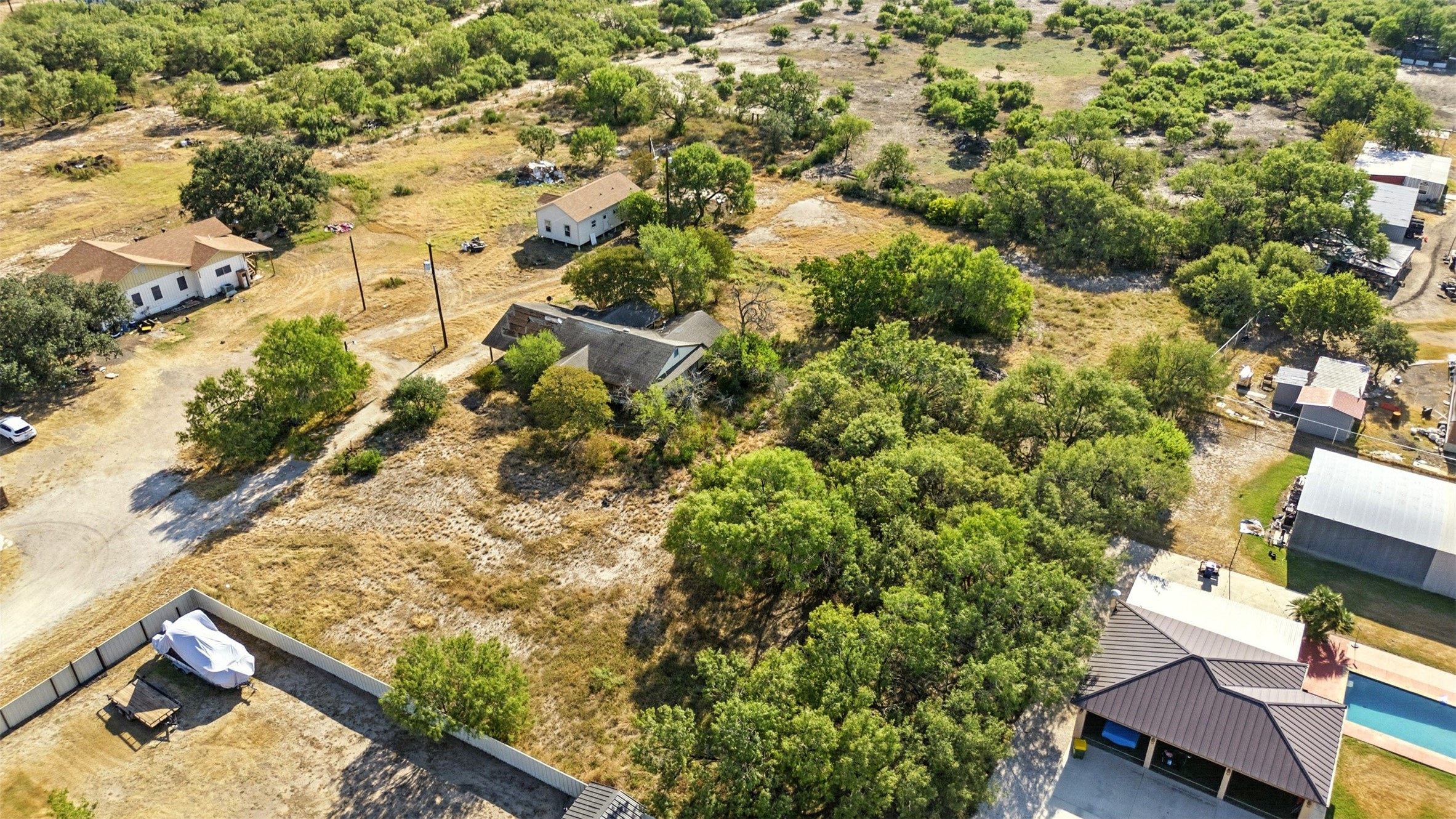 4672 Rakowitz Road Adkins, TX 78101 - Photo 38 of 38 This perspective captures the residence and its yard space, showing how the home sits within the acreage.