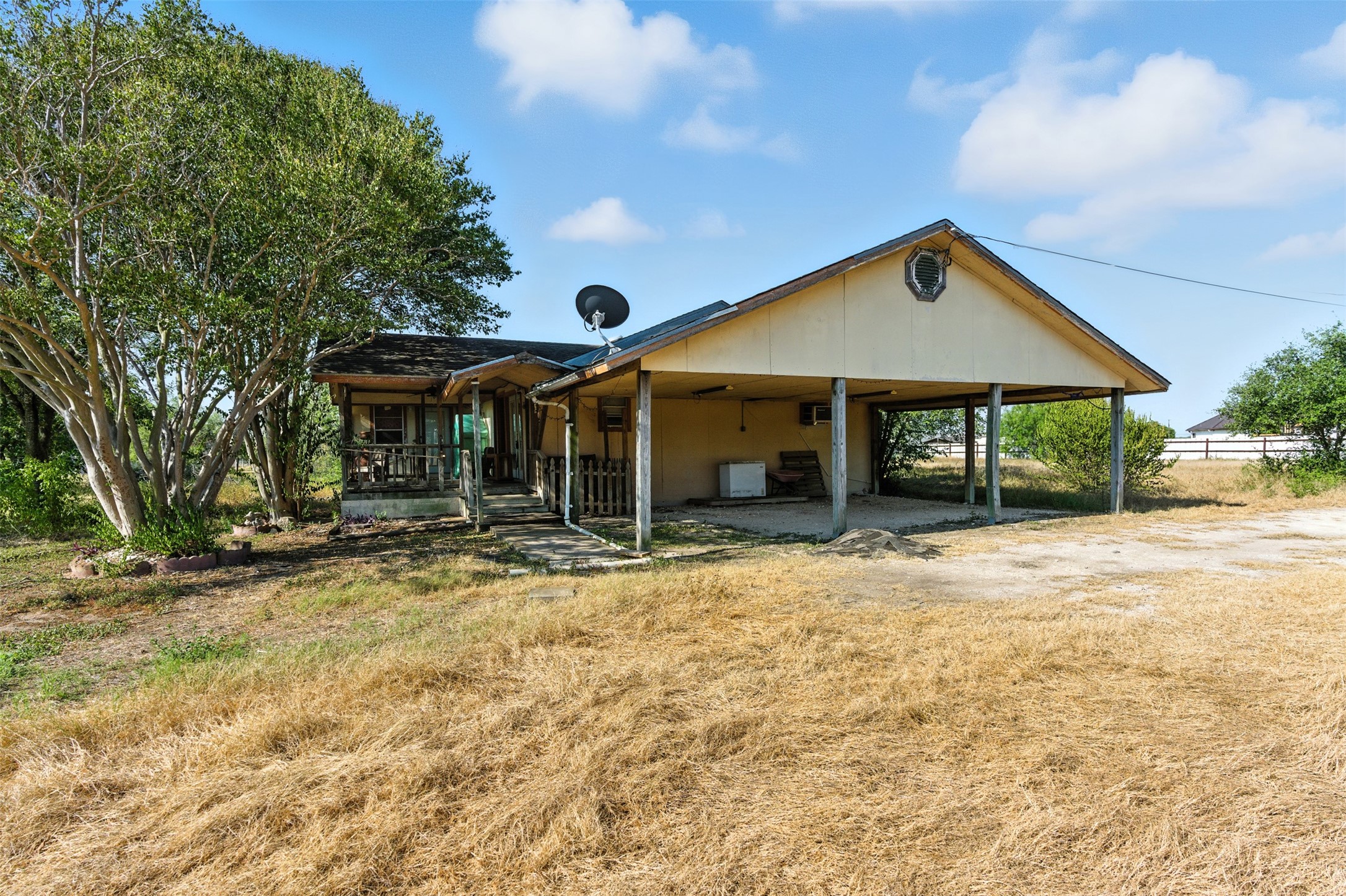 4672 Rakowitz Road Adkins, TX 78101 - Photo 4 of 38 a porch with a table and chairs under an umbrella