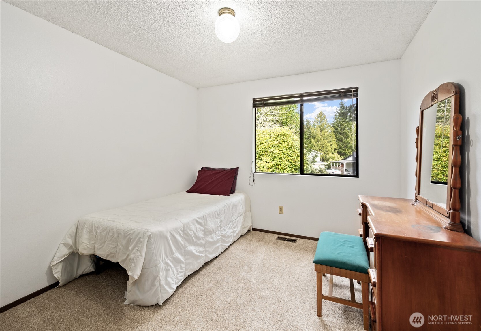 14606 60th Place West Edmonds, WA 98026 - Photo 12 of 27 a bedroom with a bed and a window
