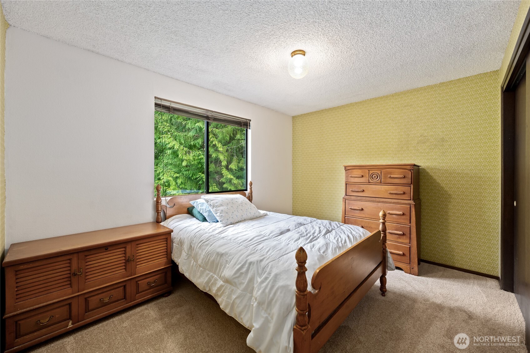 14606 60th Place West Edmonds, WA 98026 - Photo 14 of 27 a bed sitting in a bedroom next to a window
