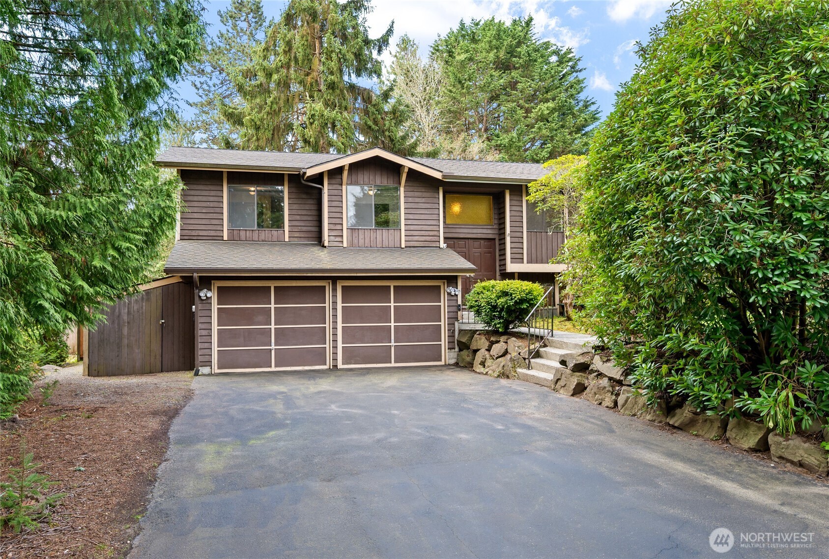 14606 60th Place West Edmonds, WA 98026 - Photo 2 of 27 a front view of a house with a yard and garage