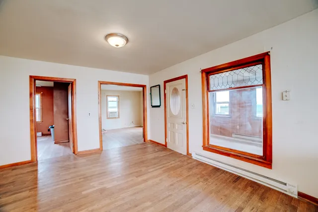 a kitchen with a table chairs and refrigerator