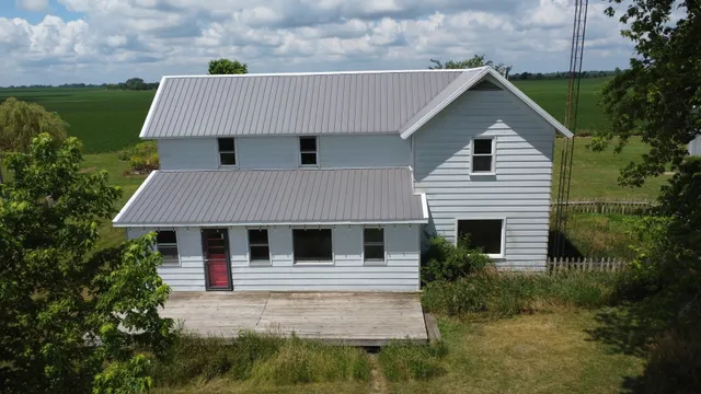 a aerial view of a house with a yard and potted plants