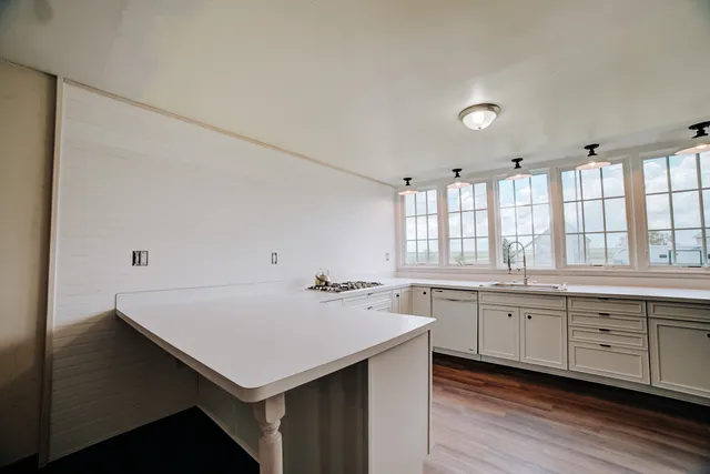 a kitchen with sink cabinets and wooden floor