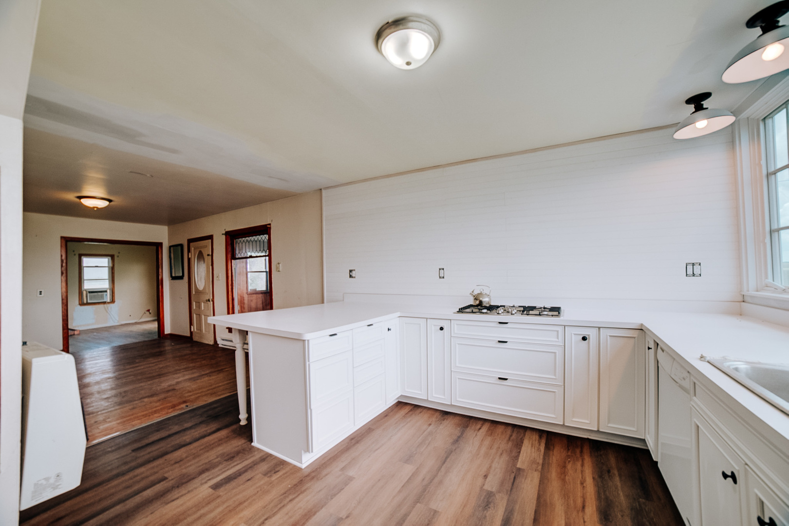 2371 North 3100 East Road Donovan, IL 60931 - Photo 23 of 45 a kitchen with sink cabinets and wooden floor