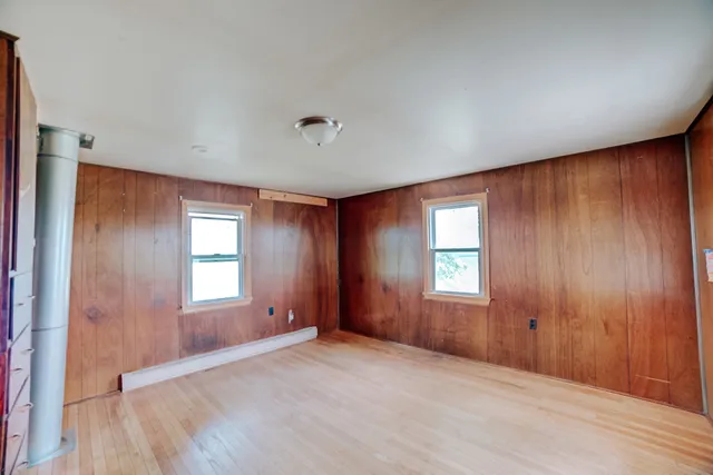 an empty room with windows and closet