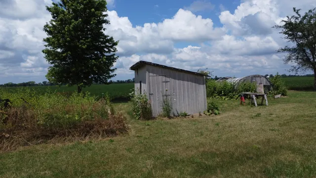 a view of a house with a yard and sitting area