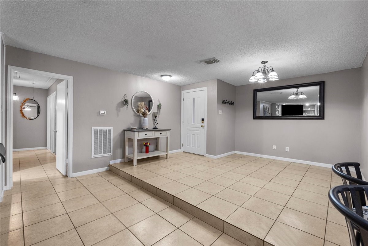883 Silverpines Road Houston, TX 77062 - Photo 4 of 38 This spacious entryway features tiled flooring, neutral walls, and modern lighting. Entry opens to an open concept living with adjacent space serving as flex space or formal dining.
