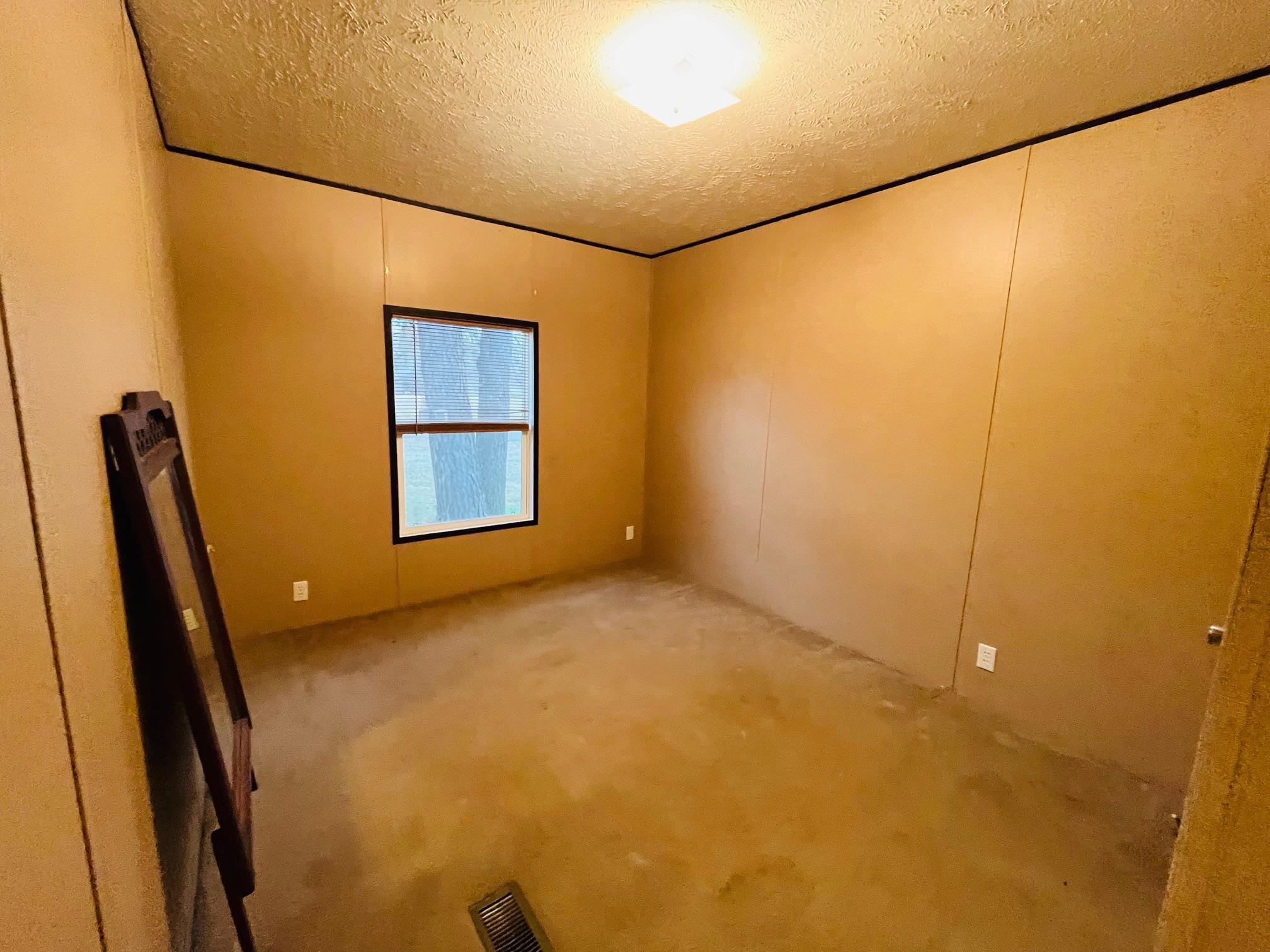 100 Stoots Road Brownsville, TN 38012 - Photo 17 of 18 Spare room featuring a textured ceiling