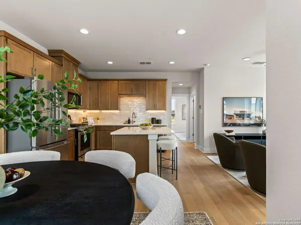 a kitchen with kitchen island wooden cabinets and counter space