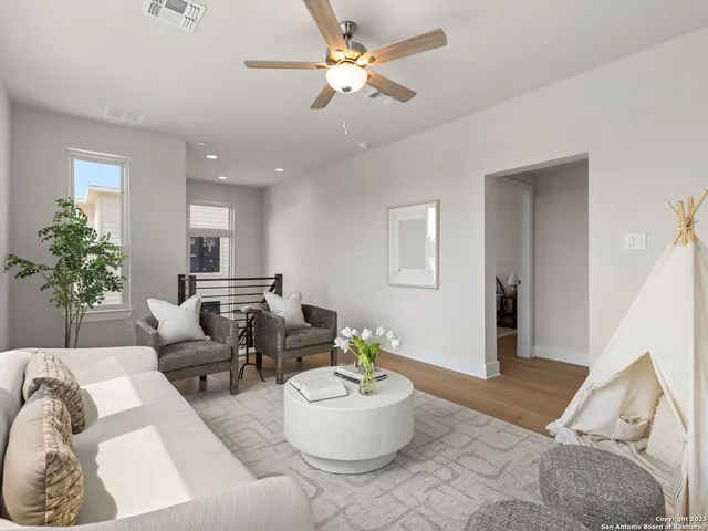 a living room with furniture and a potted plant
