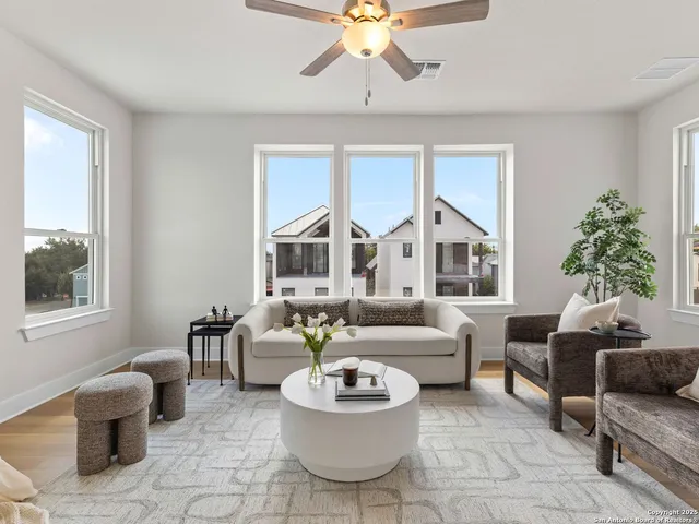 a living room with furniture and a large window