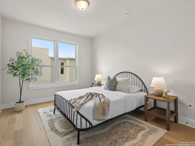 a bedroom with a bed and a potted plant