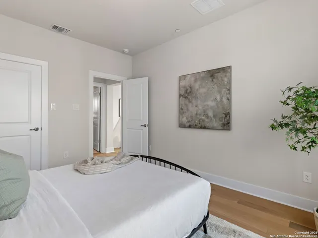 a bedroom with a bed and a potted plant