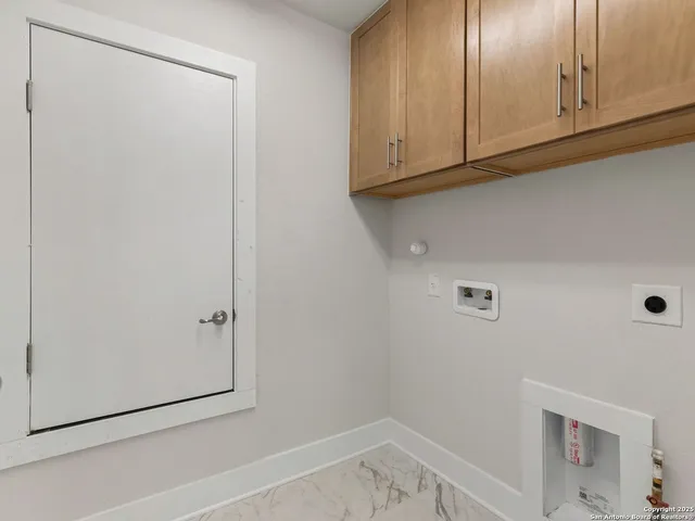 a view of storage and utility room with closet
