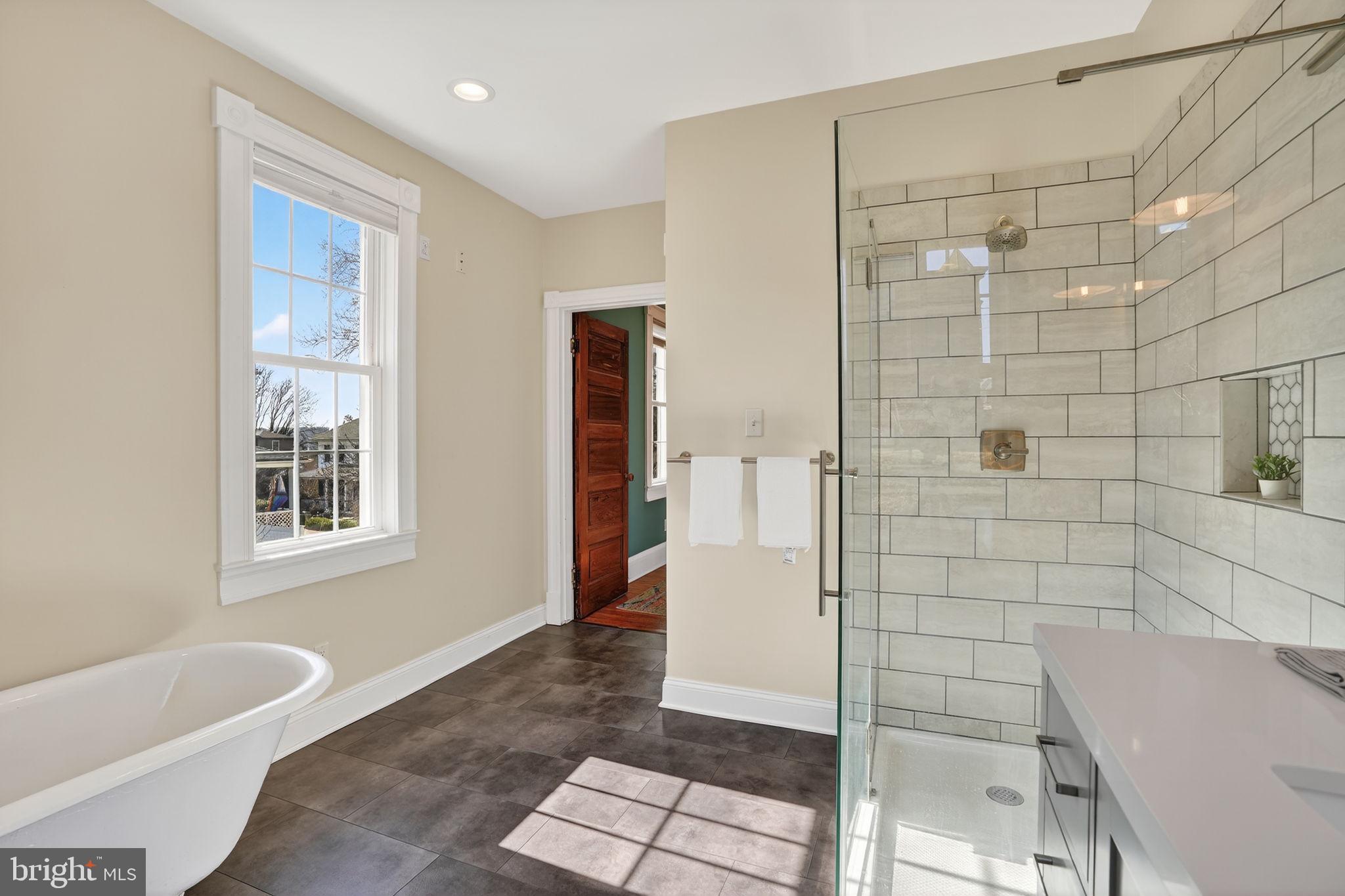 1007 Roland Heights Avenue Baltimore, MD 21211 - Photo 17 of 78 a bathroom with a bathtub and shower
