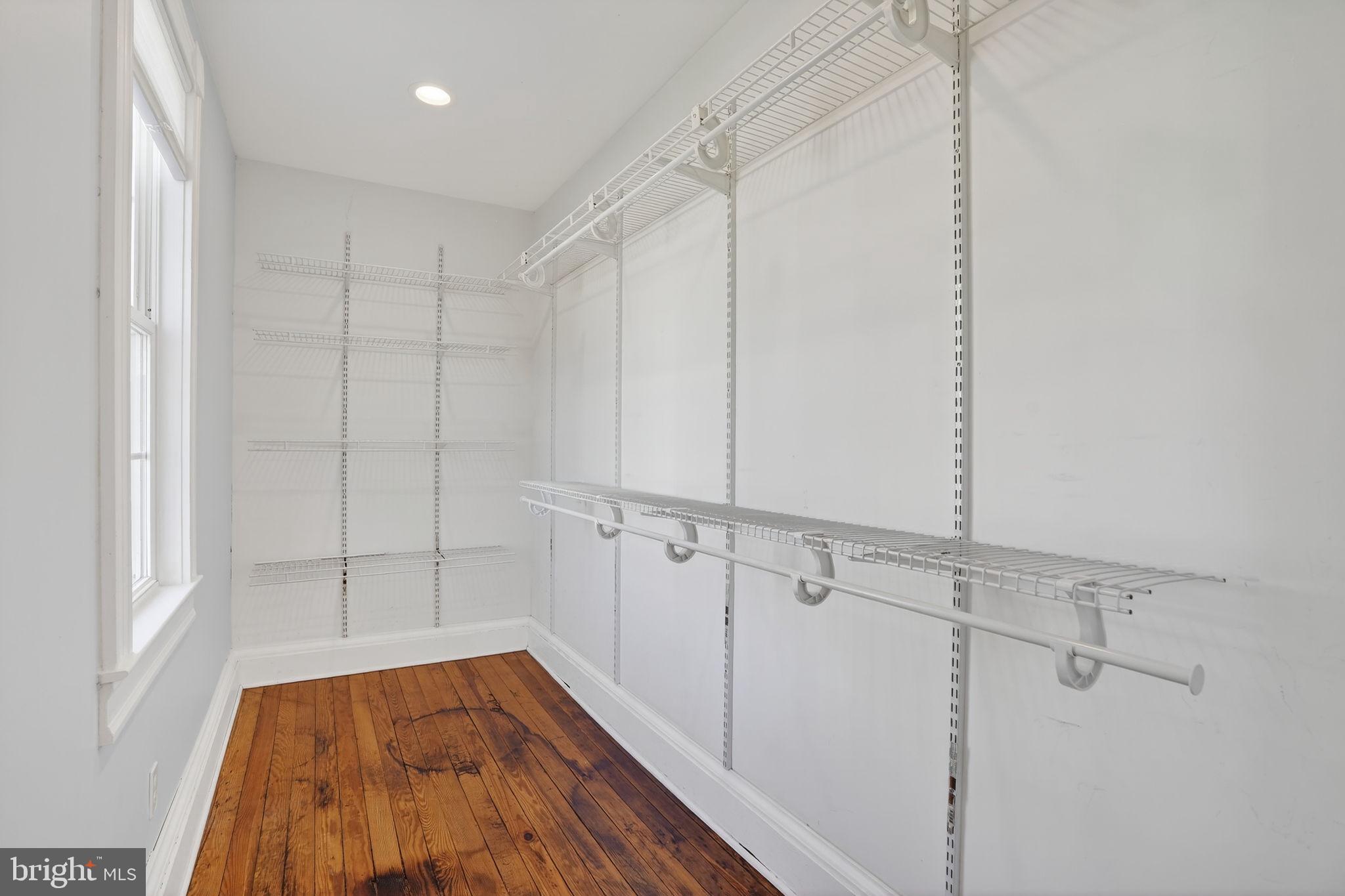 1007 Roland Heights Avenue Baltimore, MD 21211 - Photo 23 of 78 a view of walk in closet with empty racks