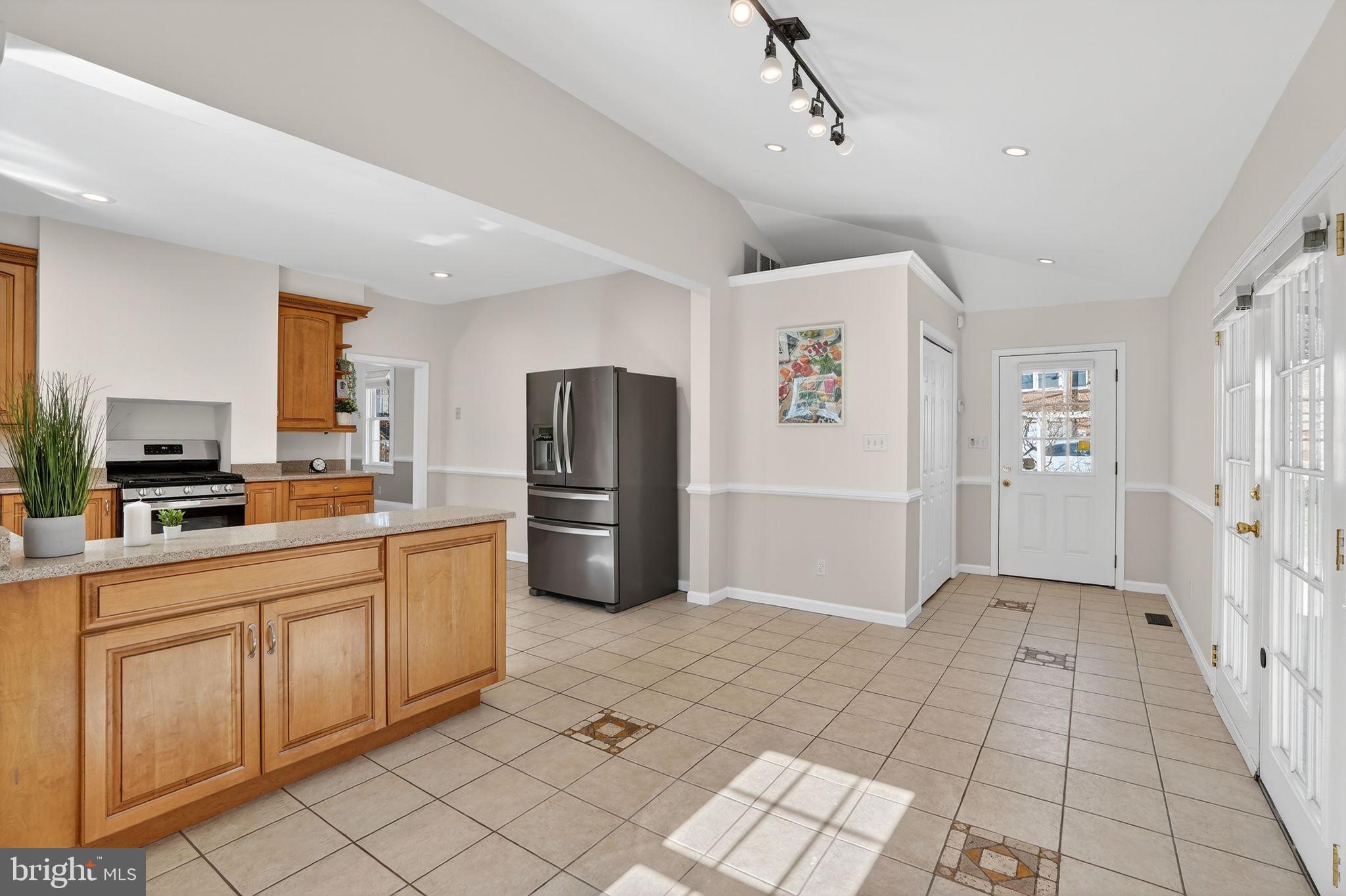 1007 Roland Heights Avenue Baltimore, MD 21211 - Photo 34 of 78 a kitchen with stainless steel appliances granite countertop a refrigerator and a sink