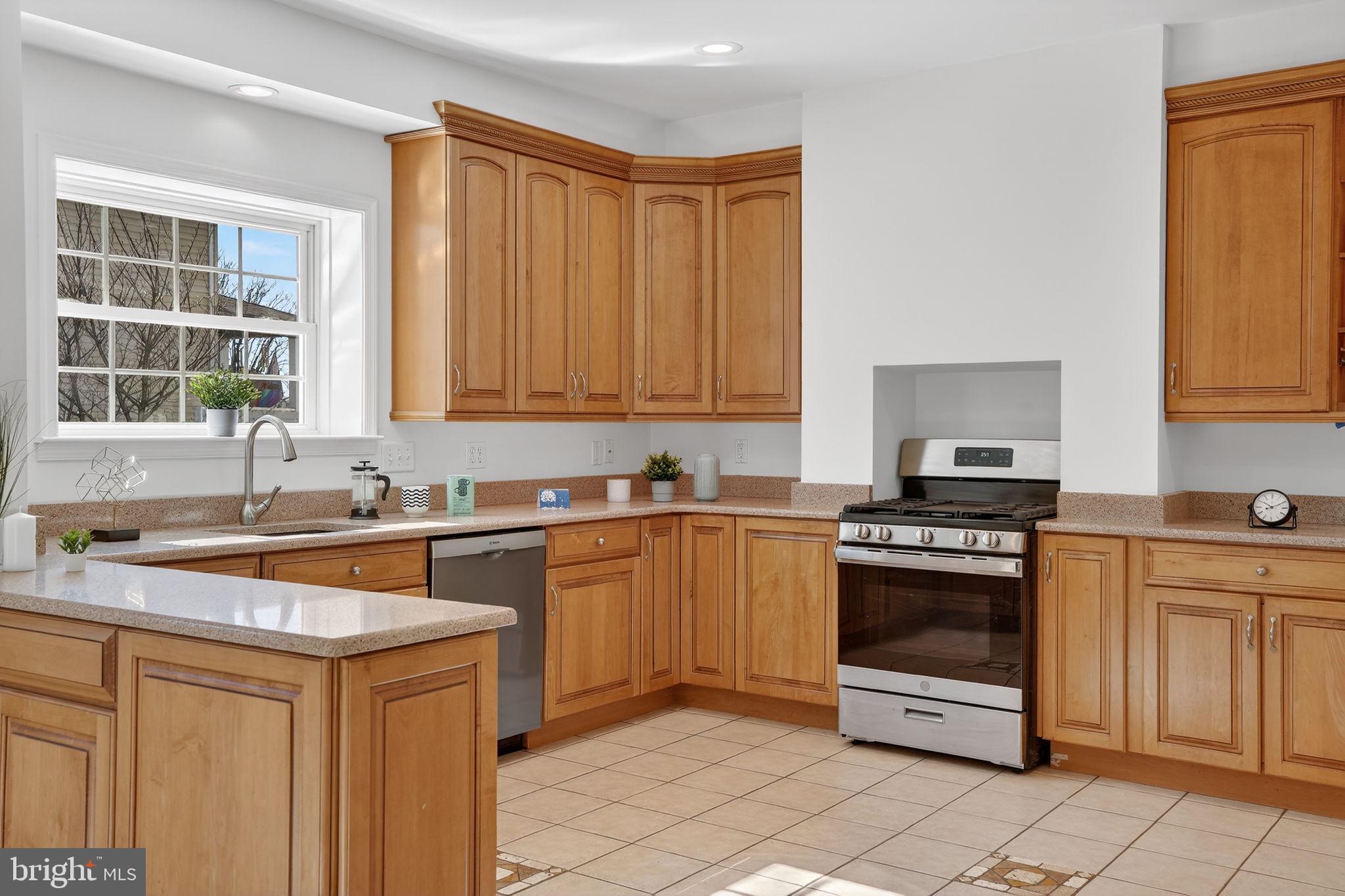 1007 Roland Heights Avenue Baltimore, MD 21211 - Photo 37 of 78 a kitchen with stainless steel appliances granite countertop a sink stove and refrigerator