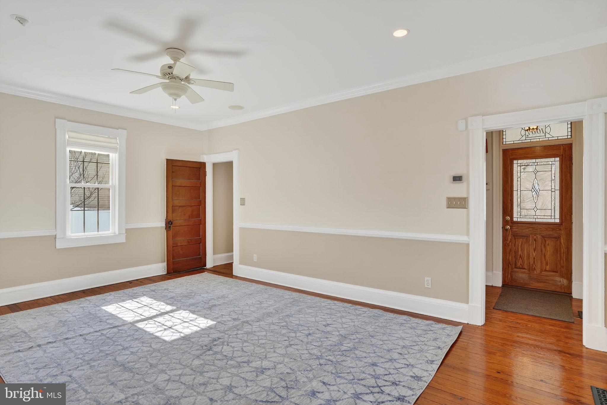 1007 Roland Heights Avenue Baltimore, MD 21211 - Photo 41 of 78 wooden floor in an empty room with a window