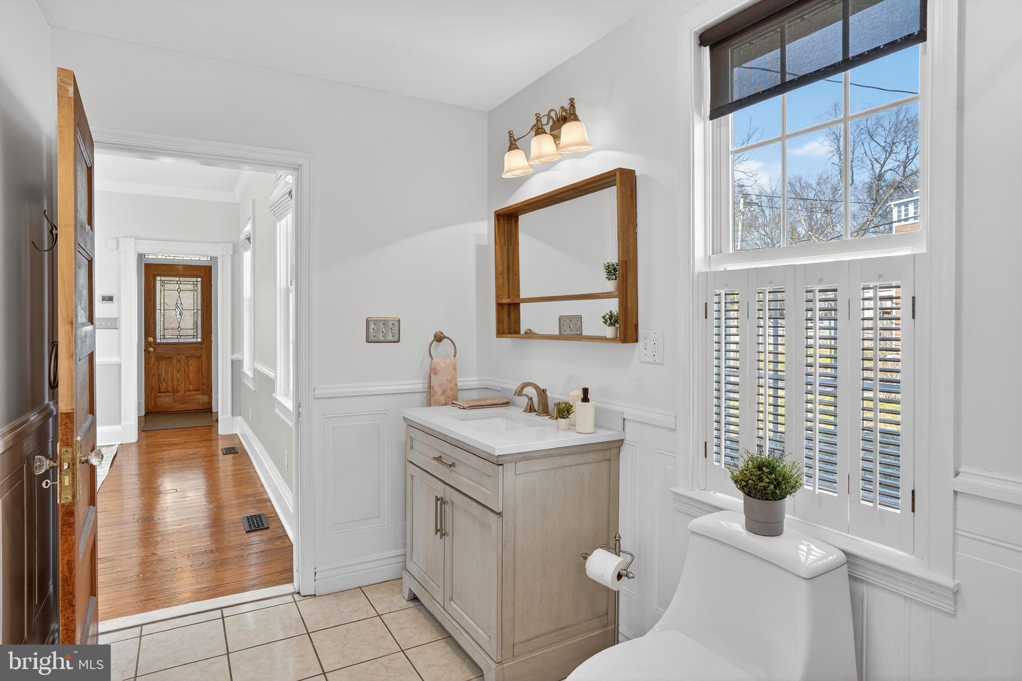 1007 Roland Heights Avenue Baltimore, MD 21211 - Photo 44 of 78 a bathroom with a toilet sink and mirror