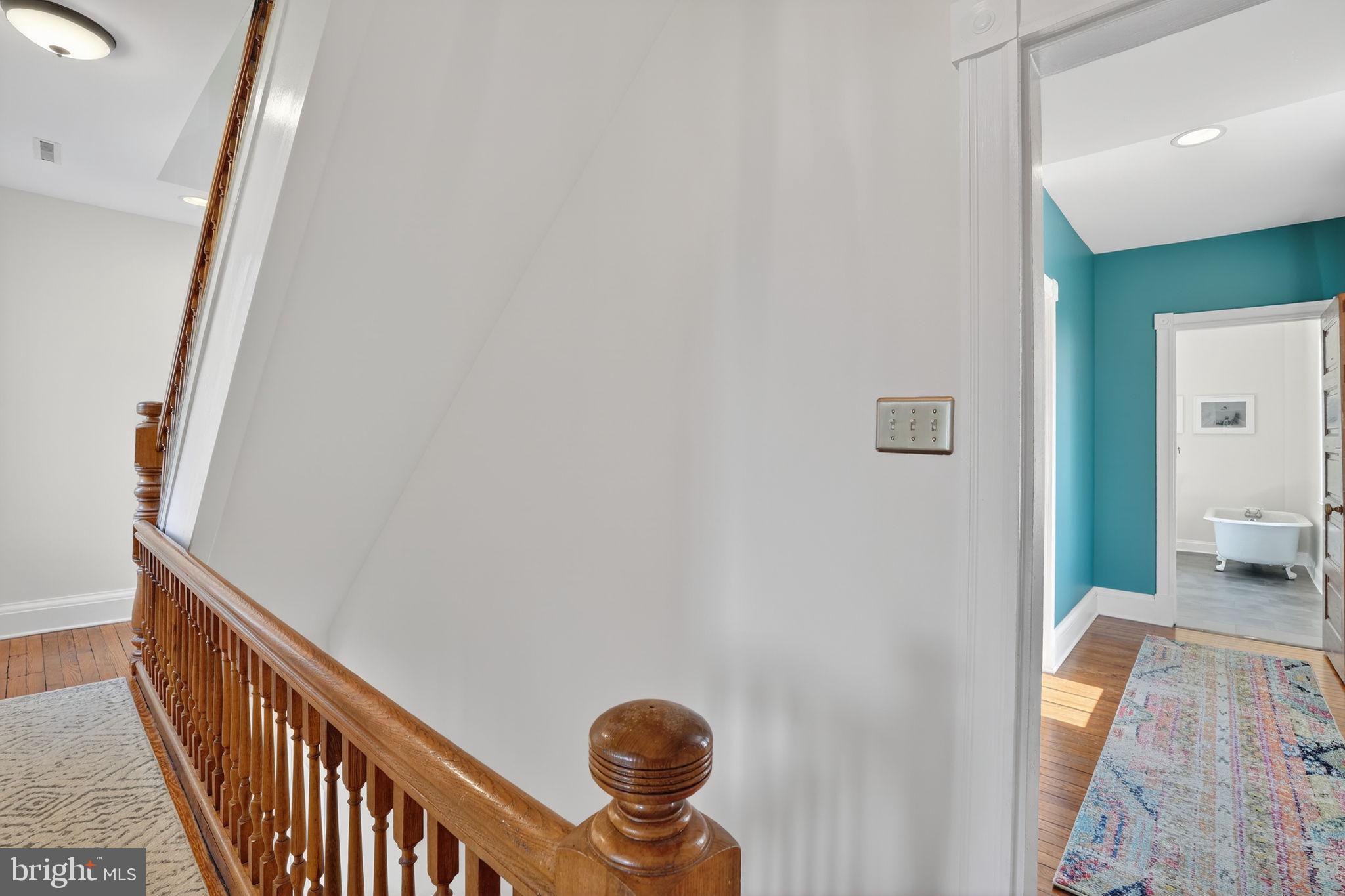 1007 Roland Heights Avenue Baltimore, MD 21211 - Photo 47 of 78 a view of a hallway with wooden floor