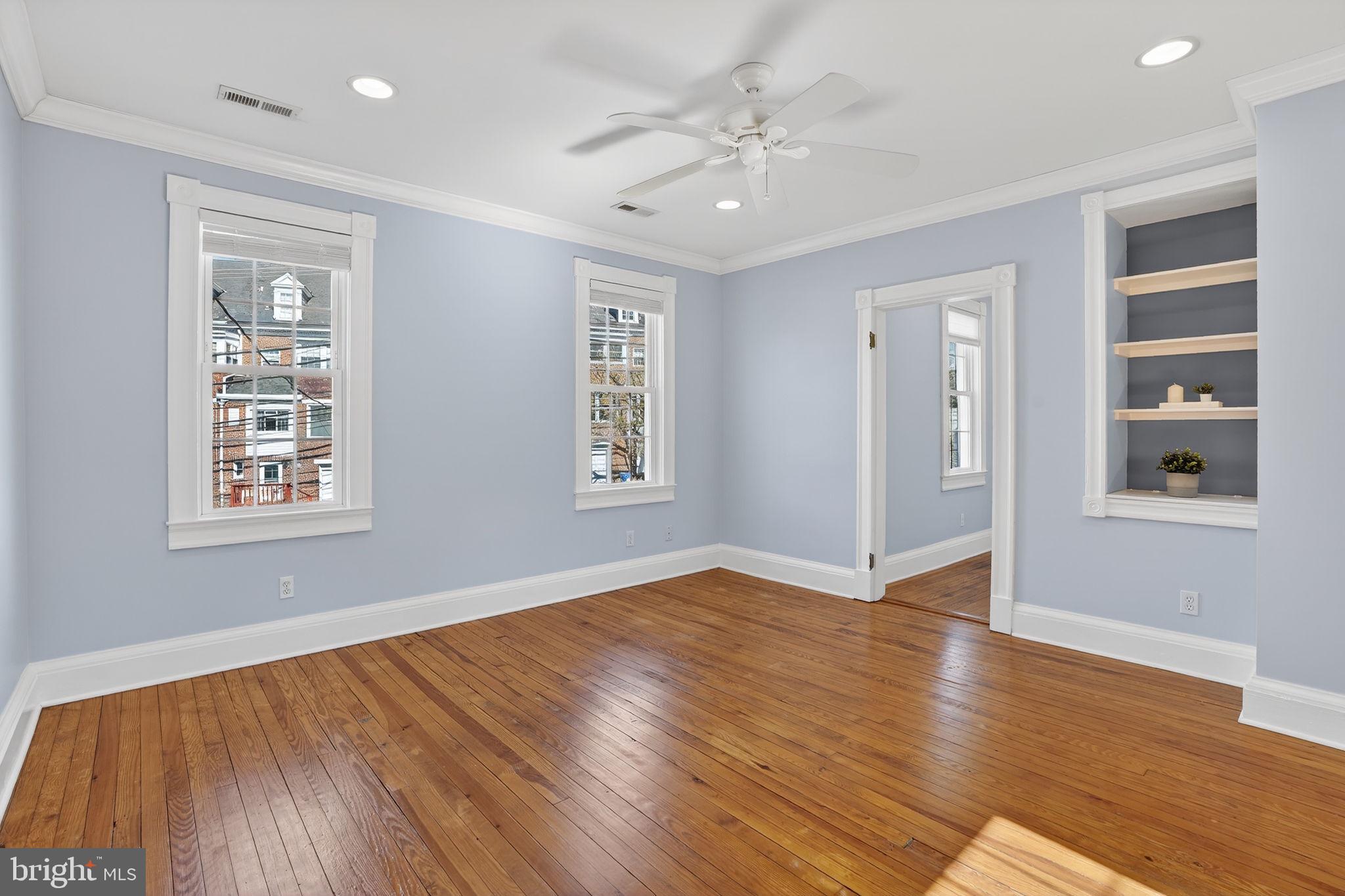 1007 Roland Heights Avenue Baltimore, MD 21211 - Photo 52 of 78 a view of an empty room with wooden floor and a window