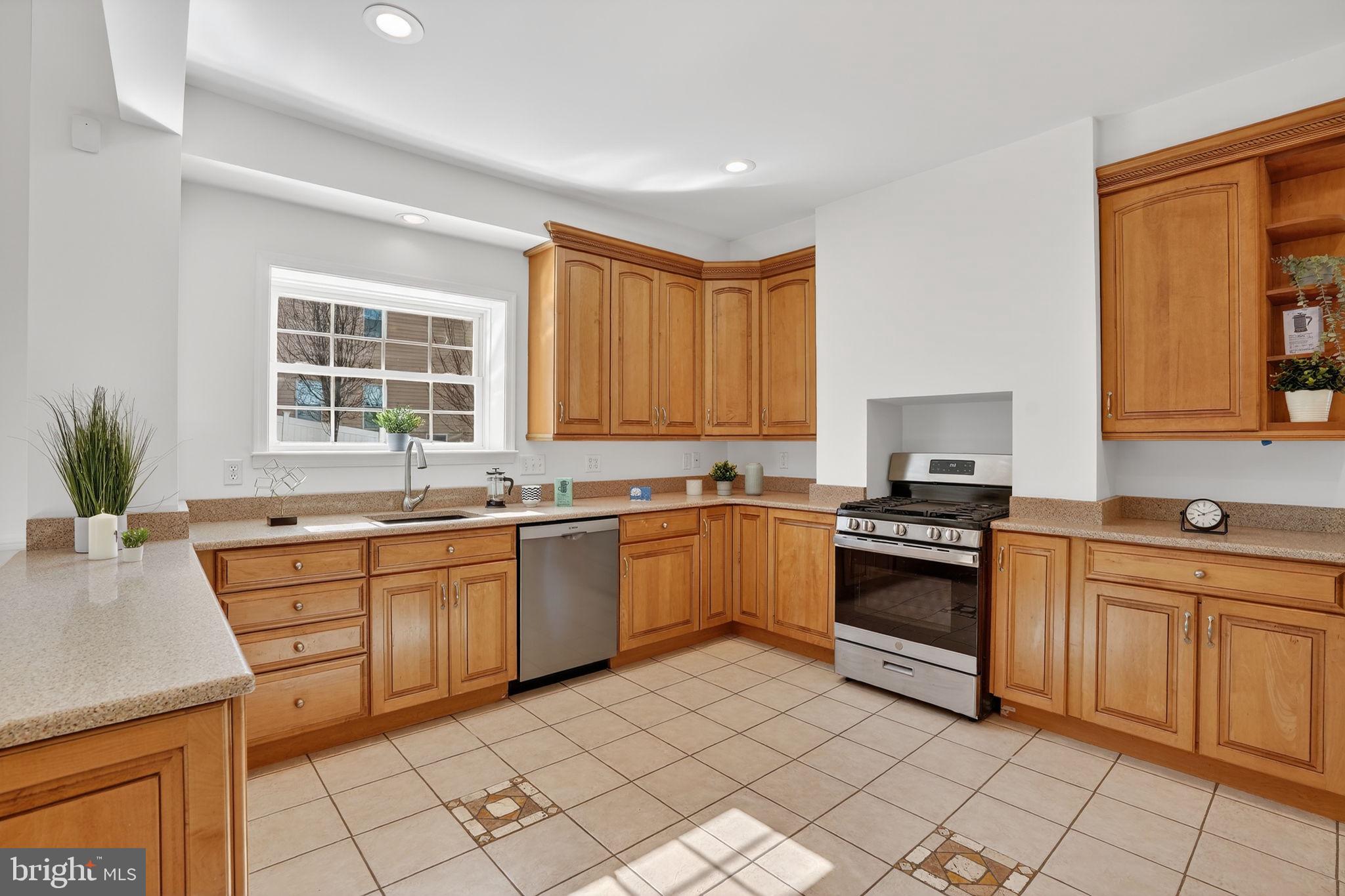 1007 Roland Heights Avenue Baltimore, MD 21211 - Photo 6 of 78 a kitchen with stainless steel appliances granite countertop a stove a sink and a microwave