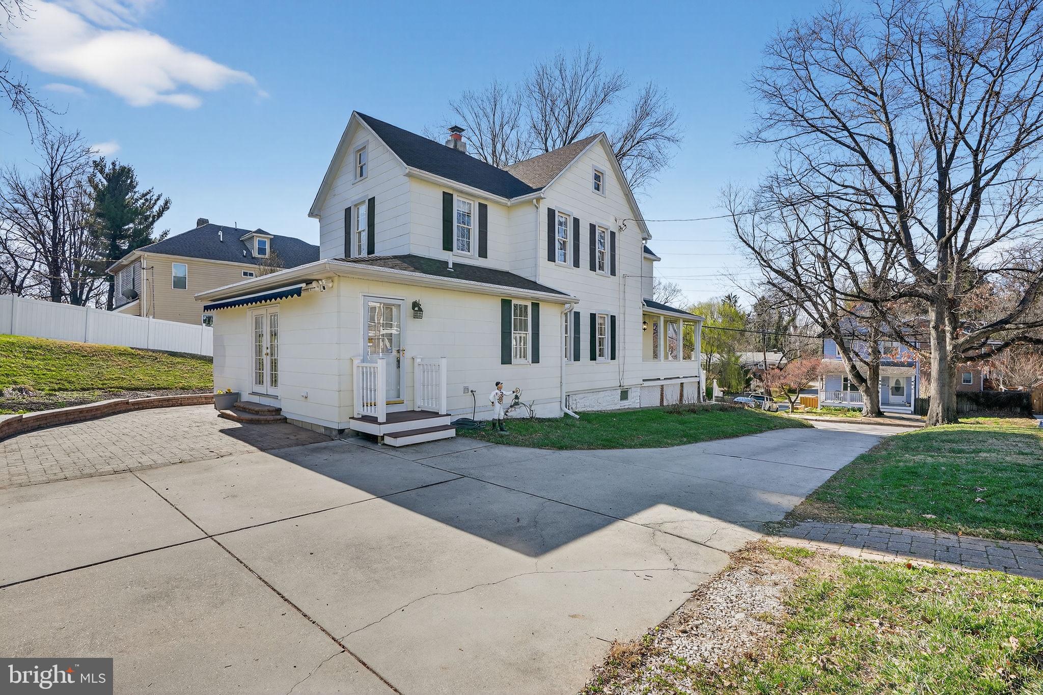 1007 Roland Heights Avenue Baltimore, MD 21211 - Photo 69 of 78 a view of a white house with a yard and large tree