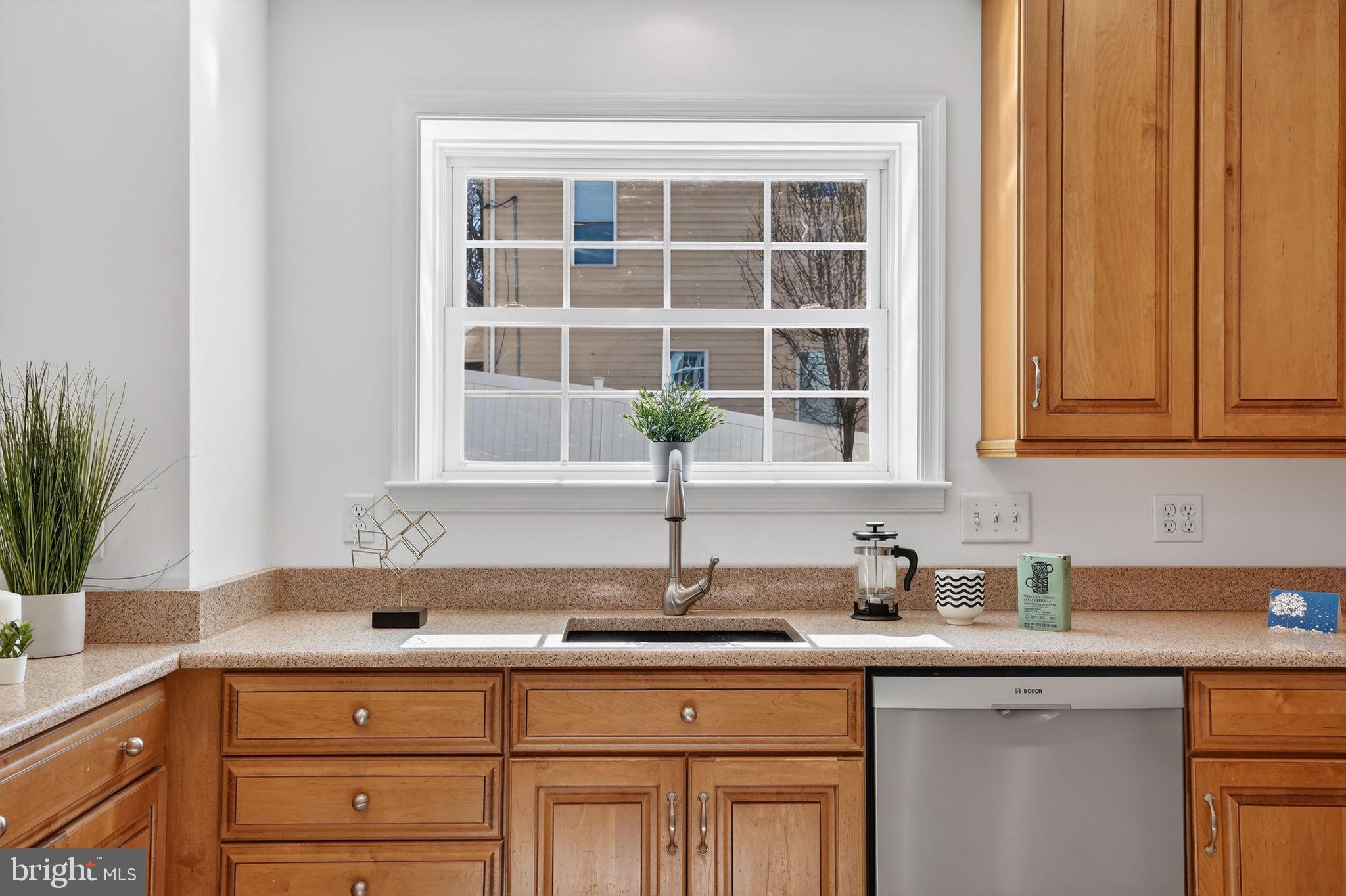 1007 Roland Heights Avenue Baltimore, MD 21211 - Photo 8 of 78 a kitchen with stainless steel appliances granite countertop a sink a window and cabinets