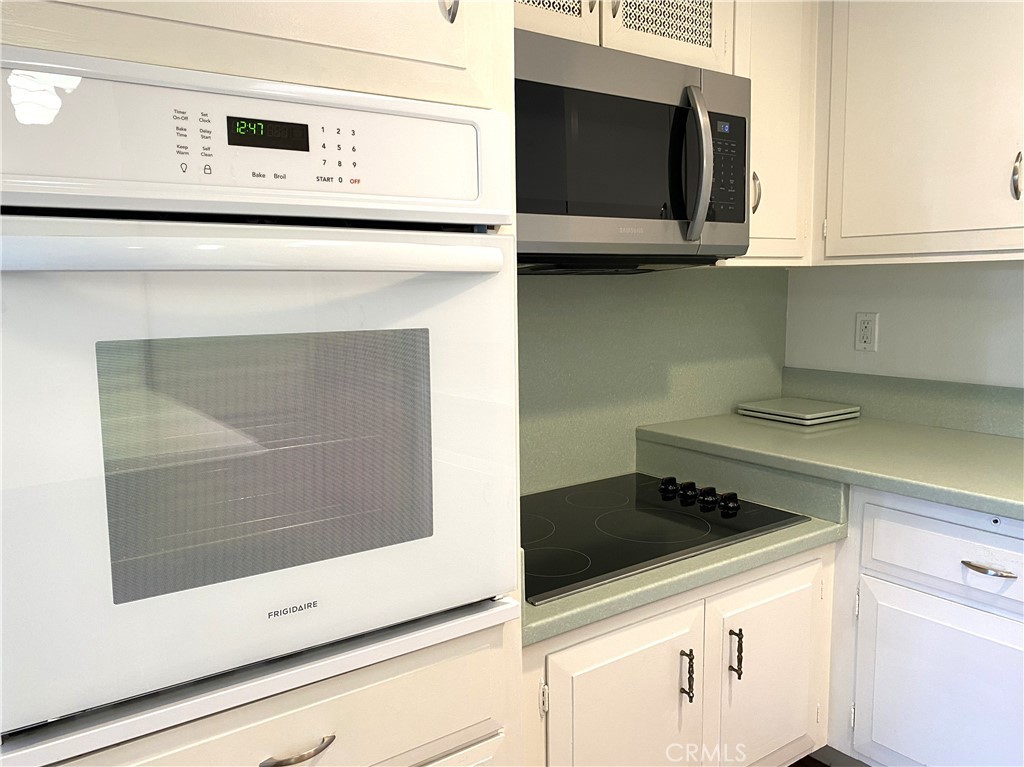1681 Monterey Road Seal Beach, CA 90740 - Photo 11 of 23 a kitchen with a stove and a microwave