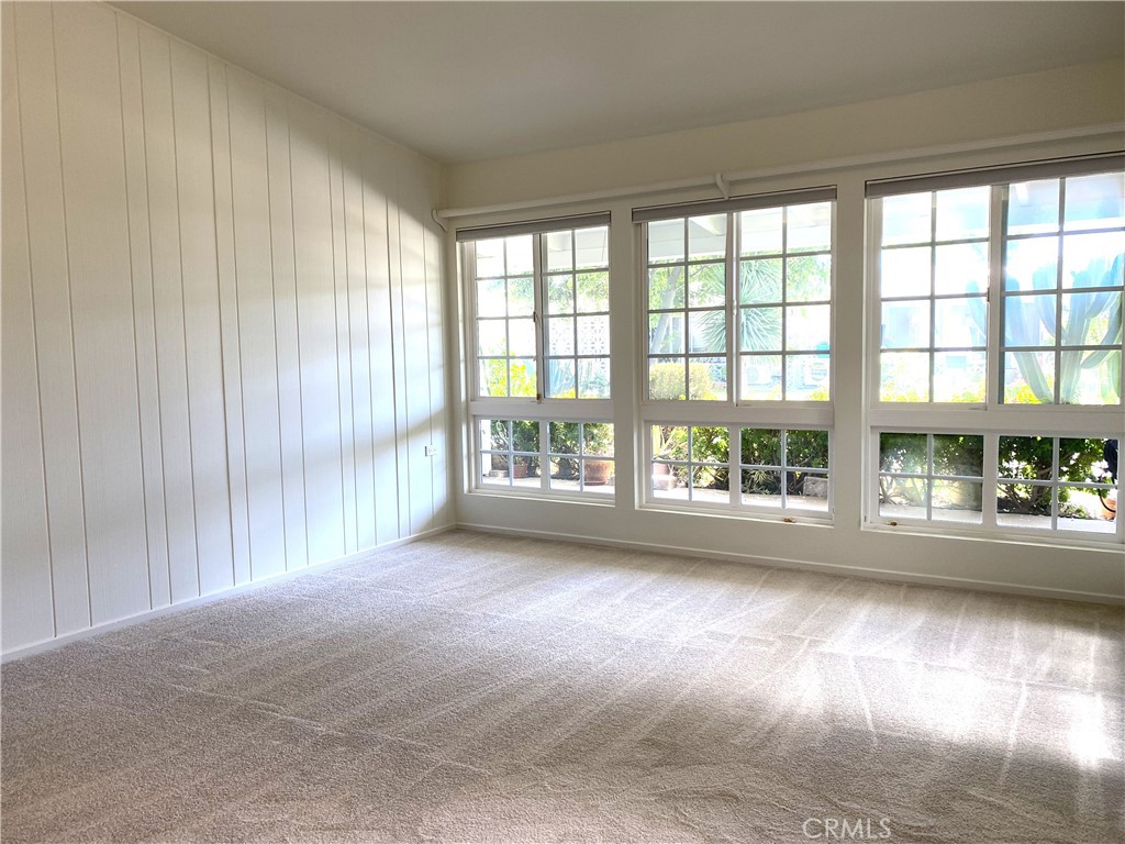 1681 Monterey Road Seal Beach, CA 90740 - Photo 12 of 23 a view of empty room with wooden floor and fan