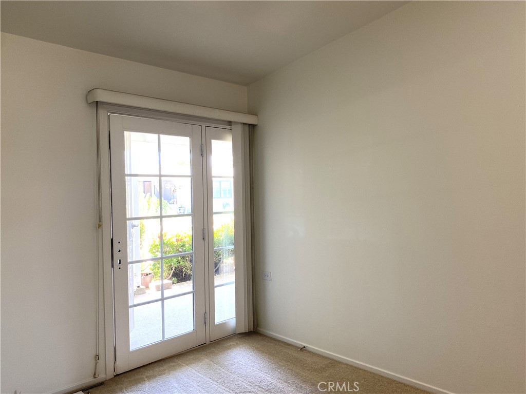 1681 Monterey Road Seal Beach, CA 90740 - Photo 17 of 23 an empty room with wooden floor and windows