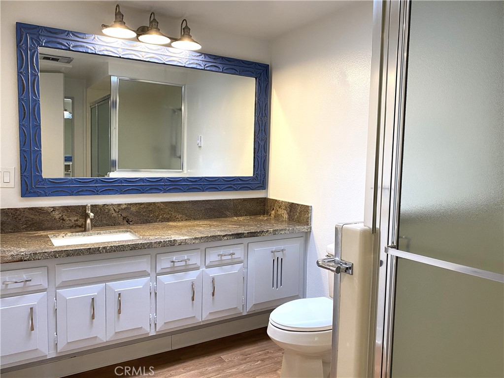 1681 Monterey Road Seal Beach, CA 90740 - Photo 19 of 23 a bathroom with a granite countertop sink vanity mirror and toilet