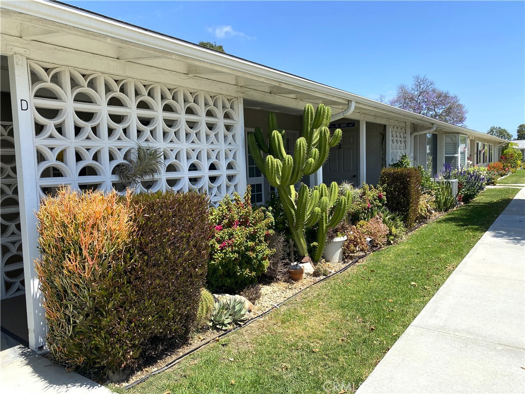 1681 Monterey Road Seal Beach, CA 90740 - Photo 2 of 23 a front view of a house with a garden