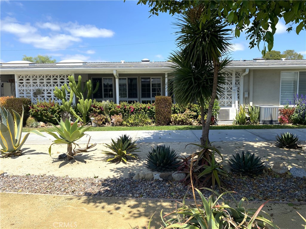 1681 Monterey Road Seal Beach, CA 90740 - Photo 6 of 23 a front view of a house with a yard and potted plants
