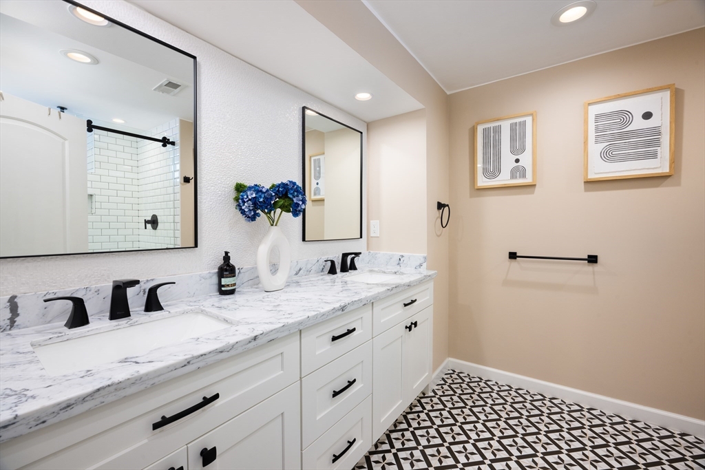 45 Bates Road, Unit 45 Watertown, MA 02472 - Photo 12 of 19 a bathroom with a granite countertop sink and a mirror