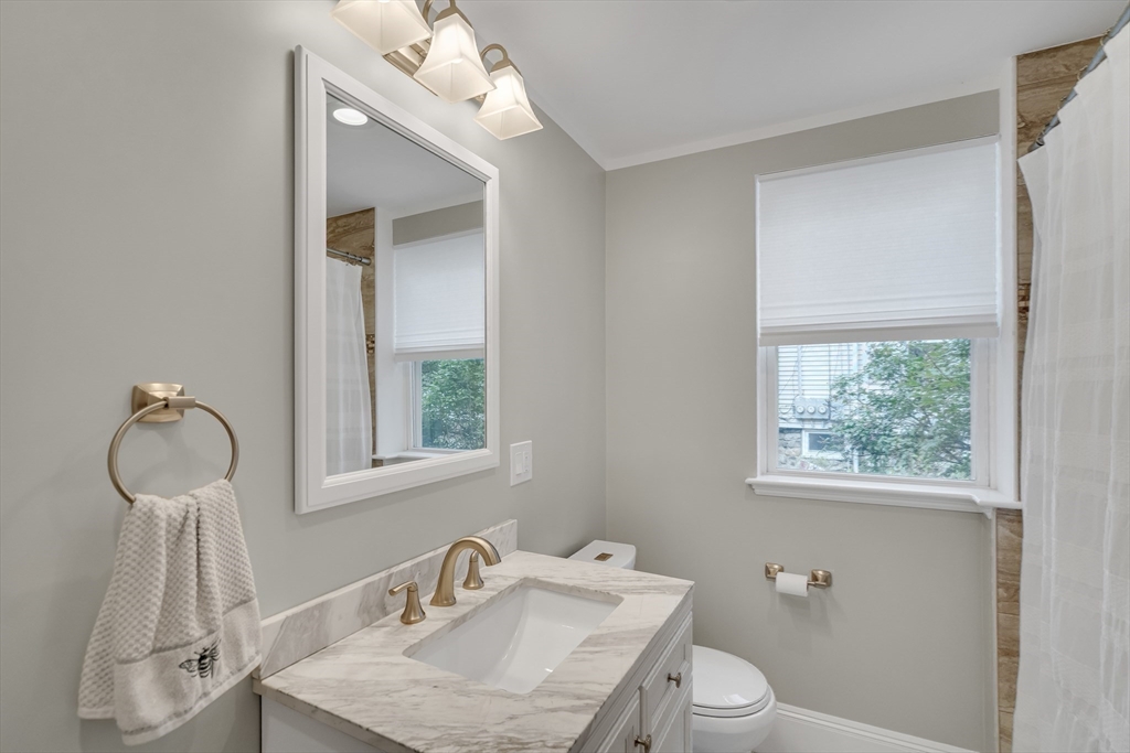 45 Bates Road, Unit 45 Watertown, MA 02472 - Photo 13 of 19 a bathroom with a sink mirror and toilet