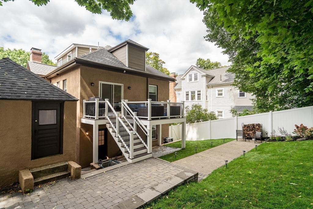 45 Bates Road, Unit 45 Watertown, MA 02472 - Photo 18 of 19 a view of a house with a large window and a yard