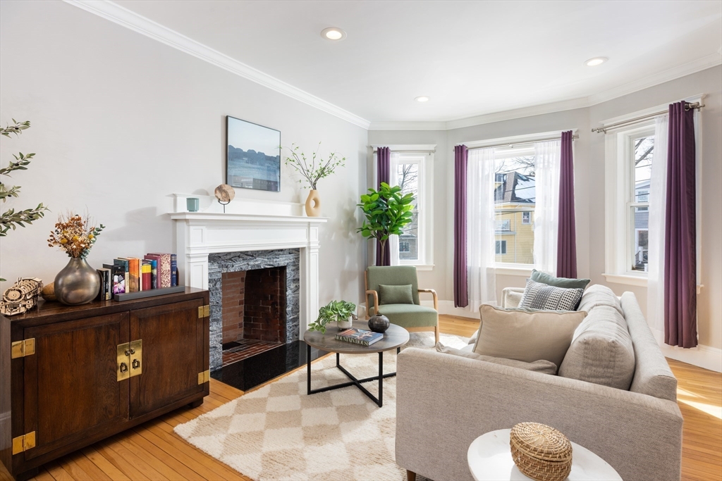 45 Bates Road, Unit 45 Watertown, MA 02472 - Photo 2 of 19 a living room with furniture and a fireplace