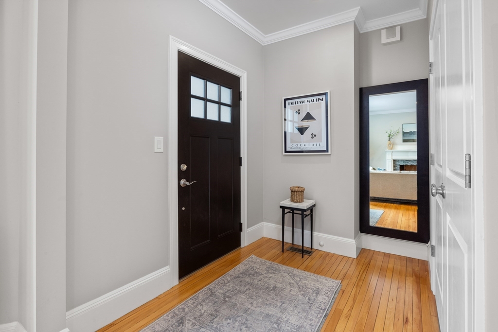 45 Bates Road, Unit 45 Watertown, MA 02472 - Photo 4 of 19 a view of a hallway with wooden floor and windows