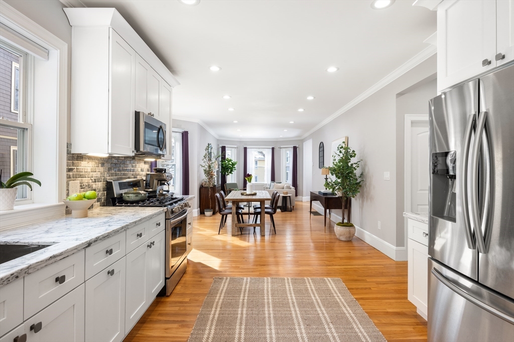 45 Bates Road, Unit 45 Watertown, MA 02472 - Photo 5 of 19 a kitchen with stainless steel appliances granite countertop a refrigerator and a sink