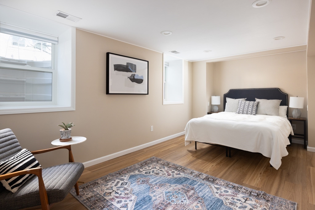 45 Bates Road, Unit 45 Watertown, MA 02472 - Photo 10 of 19 a bedroom with a bed and chair