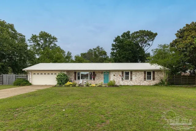 a view of house with yard and outdoor seating