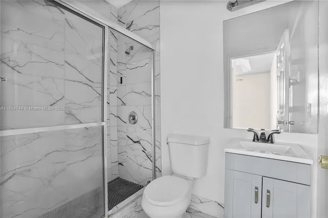 an empty room with wooden floor ceiling fan and windows
